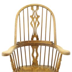 Traditional elm Windsor armchair, hooped spindle back with pierced splat, shaped elm seat, on turned supports united by double H stretcher, turned supports