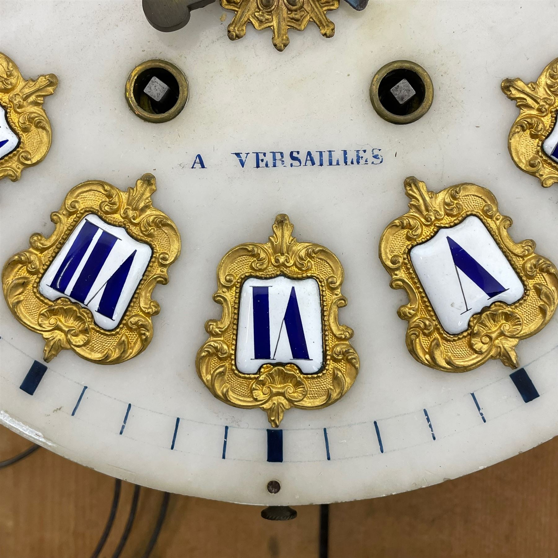 Auguste GP. Andhomme - French vineyard clock,  late 19th century 8-day twin train spring driven wall clock with enamelled and inlaid brass decoration within an ebonised and glazed case, circular enamel dial with cartouche Roman numerals, minute markers, pieced steel hands and a chased brass slip, striking movement, sounding the hours and half hours on a coiled gong. With pendulum and key.  
