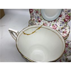 Windsor tea service for six decorated with blooming pink roses and purple flowers amongst foliage