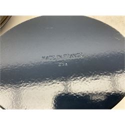 Emile Henry covered casserole dish of oval form in two tone brown and cream, no. 03.06, together with cast iron Nomar twin handled lidded casserole dish of oval form in navy, and other ovenware including Flintware ICTC, largest L35cm