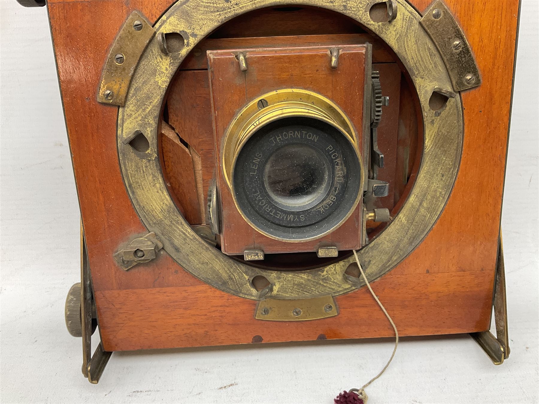 Thornton Pickard Imperial Triple folding plate camera in mahogany and lacquered brass, field model, three mahogany photographic plates and a wooden tripod