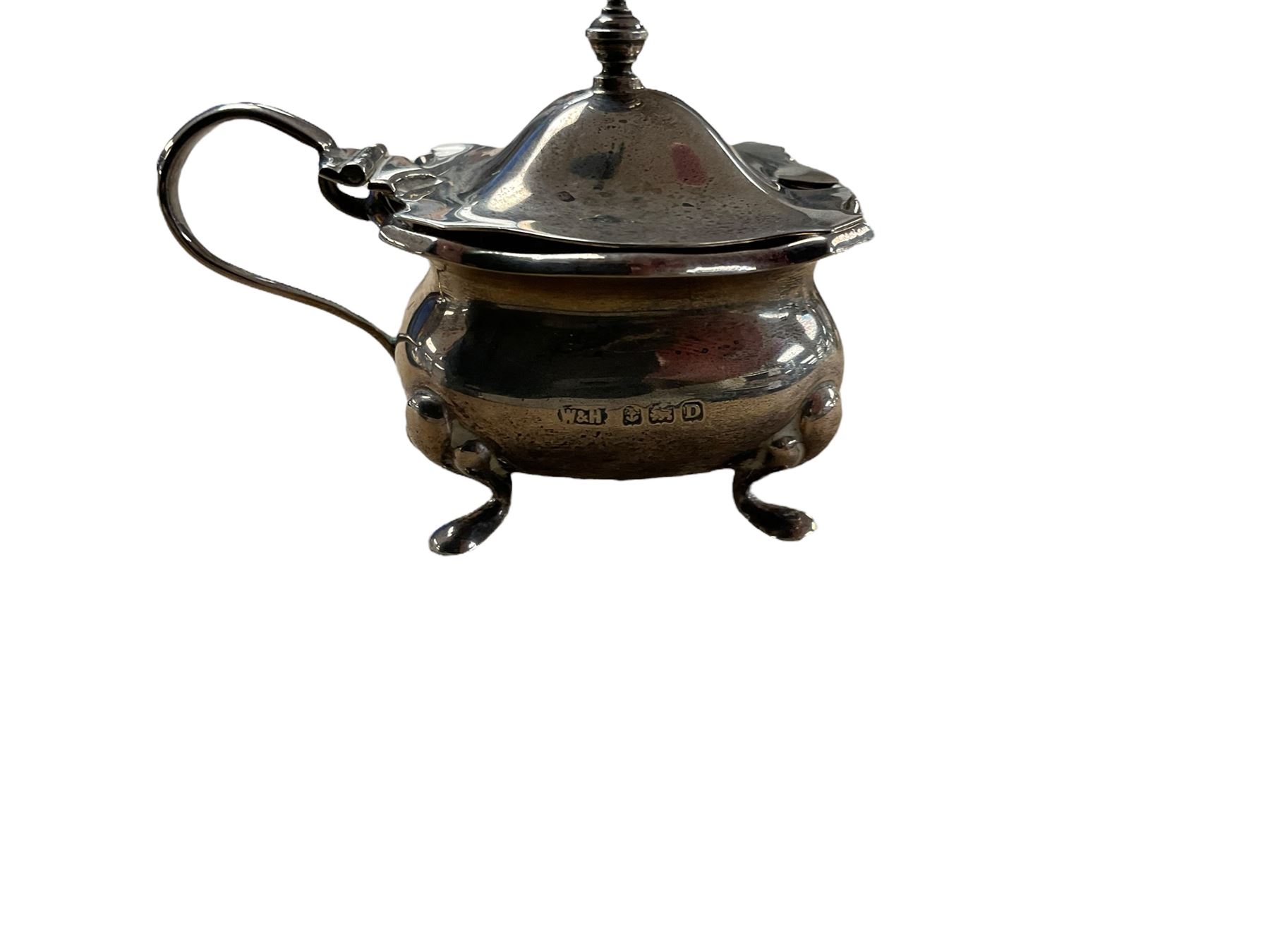 1920s silver three piece part cruet set, comprising pepper shakers, open salt with blue glass liner and a mustard pot, all upon four pad feet, hallmarked White & Hawkins, Birmingham,  , with three silver salt spoons, hallmarked 