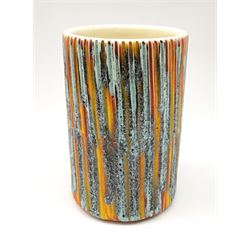 A Poole Pottery Delphis vase, shape 83, with textured effect in merging tones of red, yellow and blue, with printed mark beneath, H15cm.