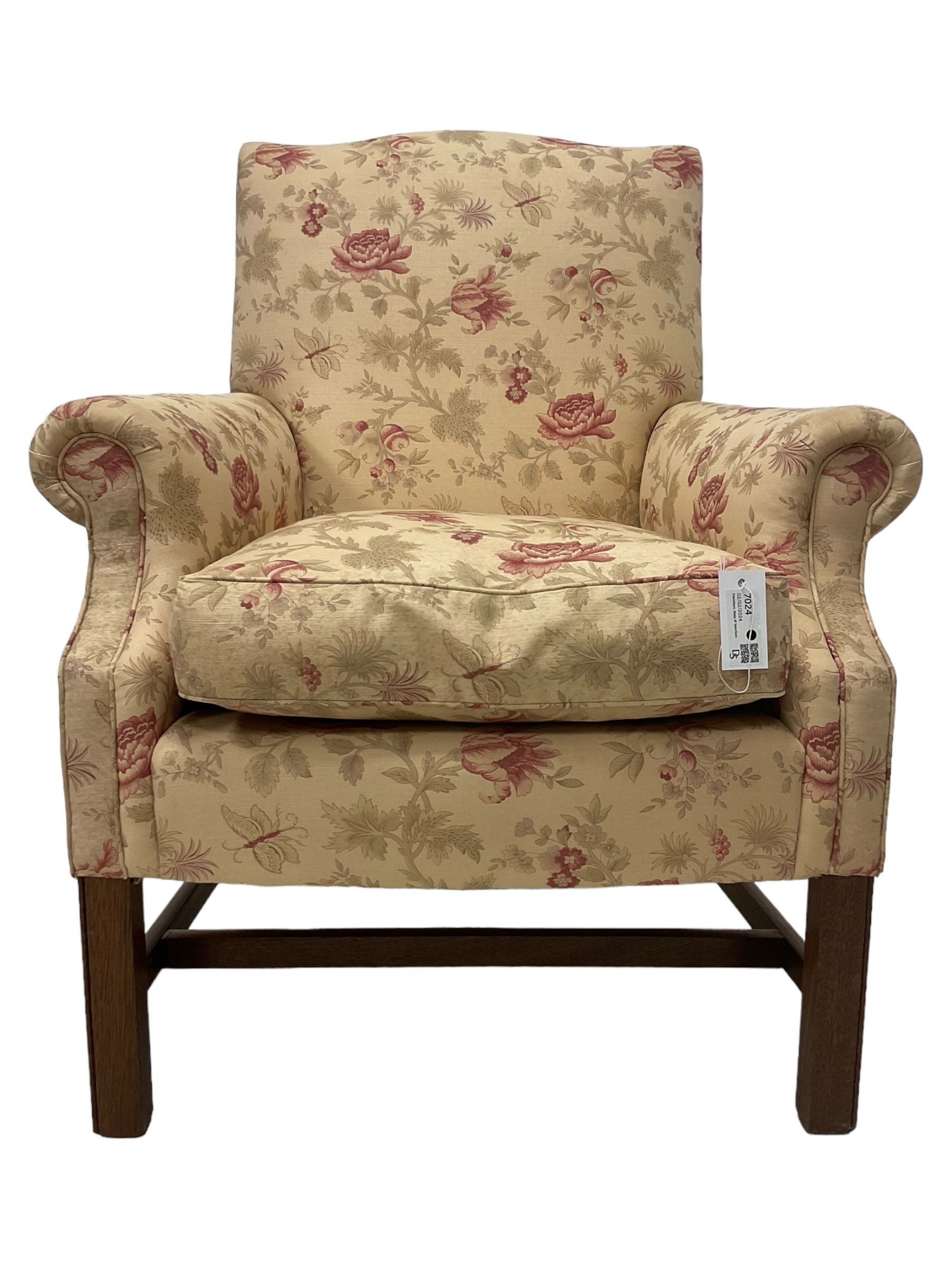 Peter Dudgeon - Georgian design mahogany framed armchair, shaped cresting rail over sprung back and seat flanked by rolled arms, upholstered in floral patterned fabric with matching seat cushion, on square supports joined by stretchers
Provenance: From the Estate of the late Dowager Lady St Oswald