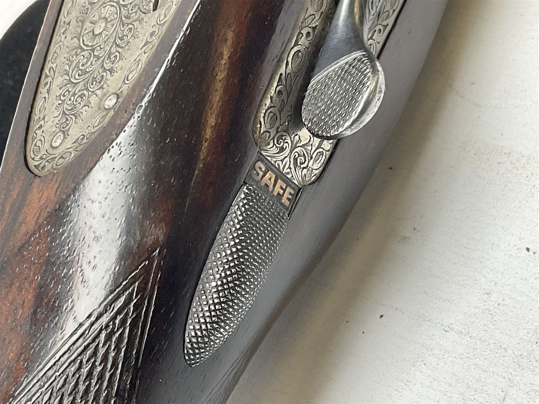 Smith Midgley Bradford 12-bore side-by-side double barrel side-lock ejector shotgun with 71cm barrels, engraved action with patented top lever, ivy leaf fences and top safety, walnut stock with chequered grip and fore-end, serial no.62409 to barrels and 1481 to action, L115cm overall SHOTGUN CERTIFICATE REQUIRED