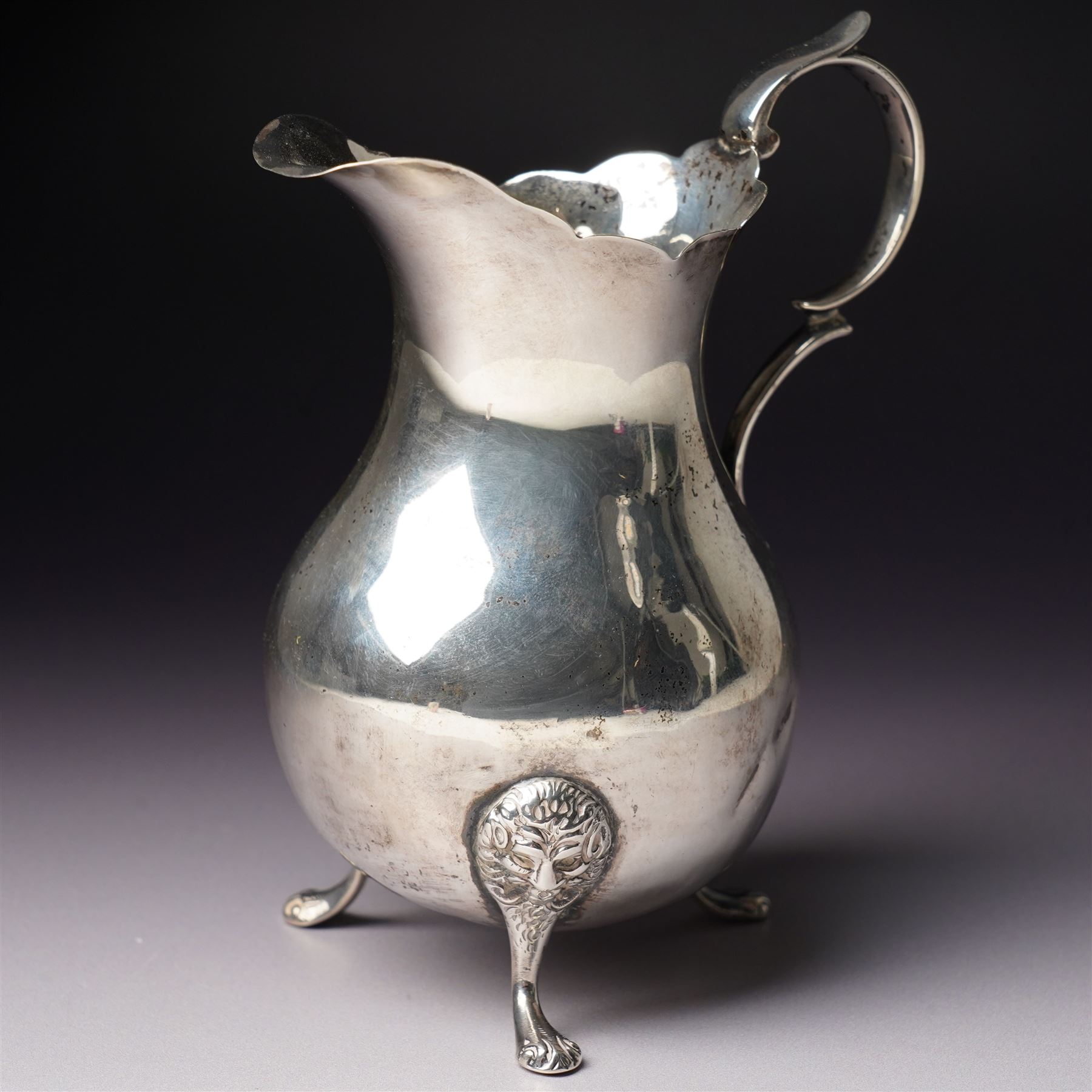 Victorian silver cream jug with crimped rim, scroll handle and lion mask supports London  1887 Maker John Aldwinckle and Thomas Slater
