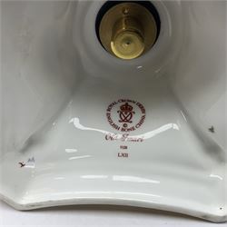 Pair of modern Royal Crown Derby Old Imari 1128 pattern candlesticks, each with shaped drip tray affixed to squat socket, upon spreading stem and canted square base with gilt dolphin edges, with printed marks beneath including Roman numeral year cypher for 2003, H26.5cm, with original boxes