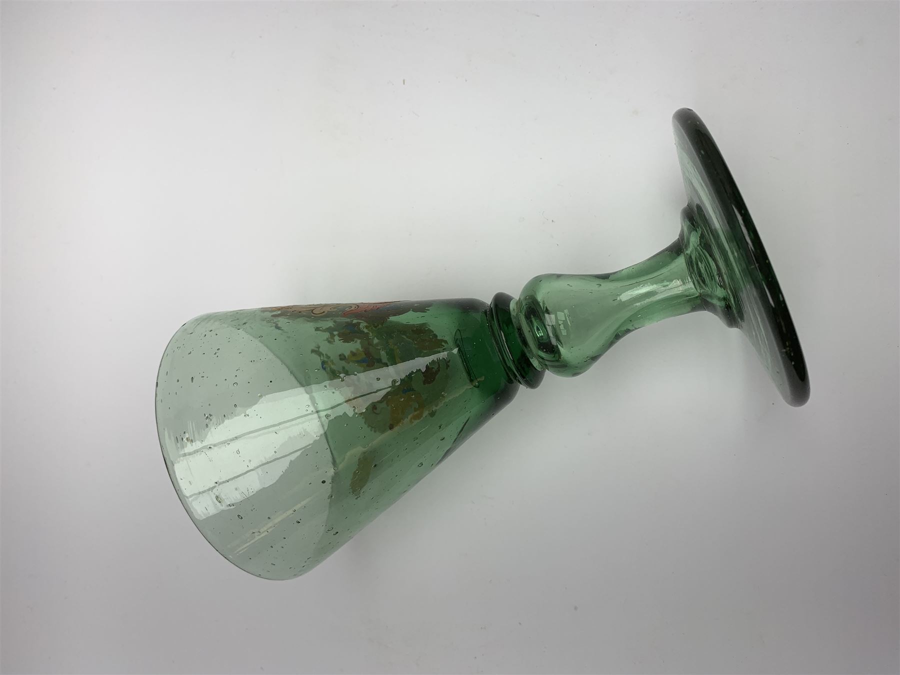 19th century bohemian green glass wine glass, the funnel bowl decorated in enamells with a Historismus hunting scene in the manner of Egermann & Lobmeyr, upon a baluster stem and circular foot, H14.5cm