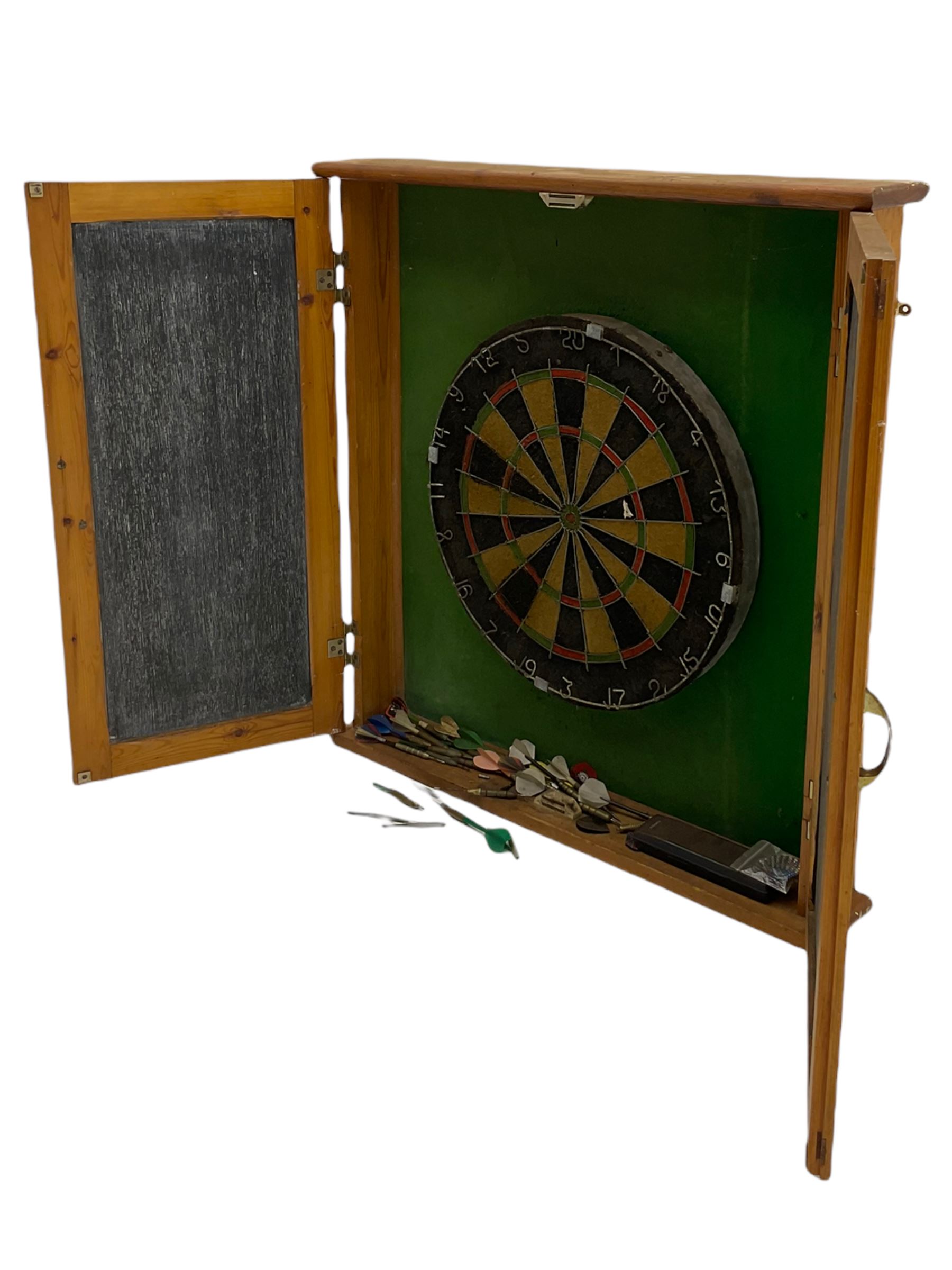 Dart board in wooden cabinet