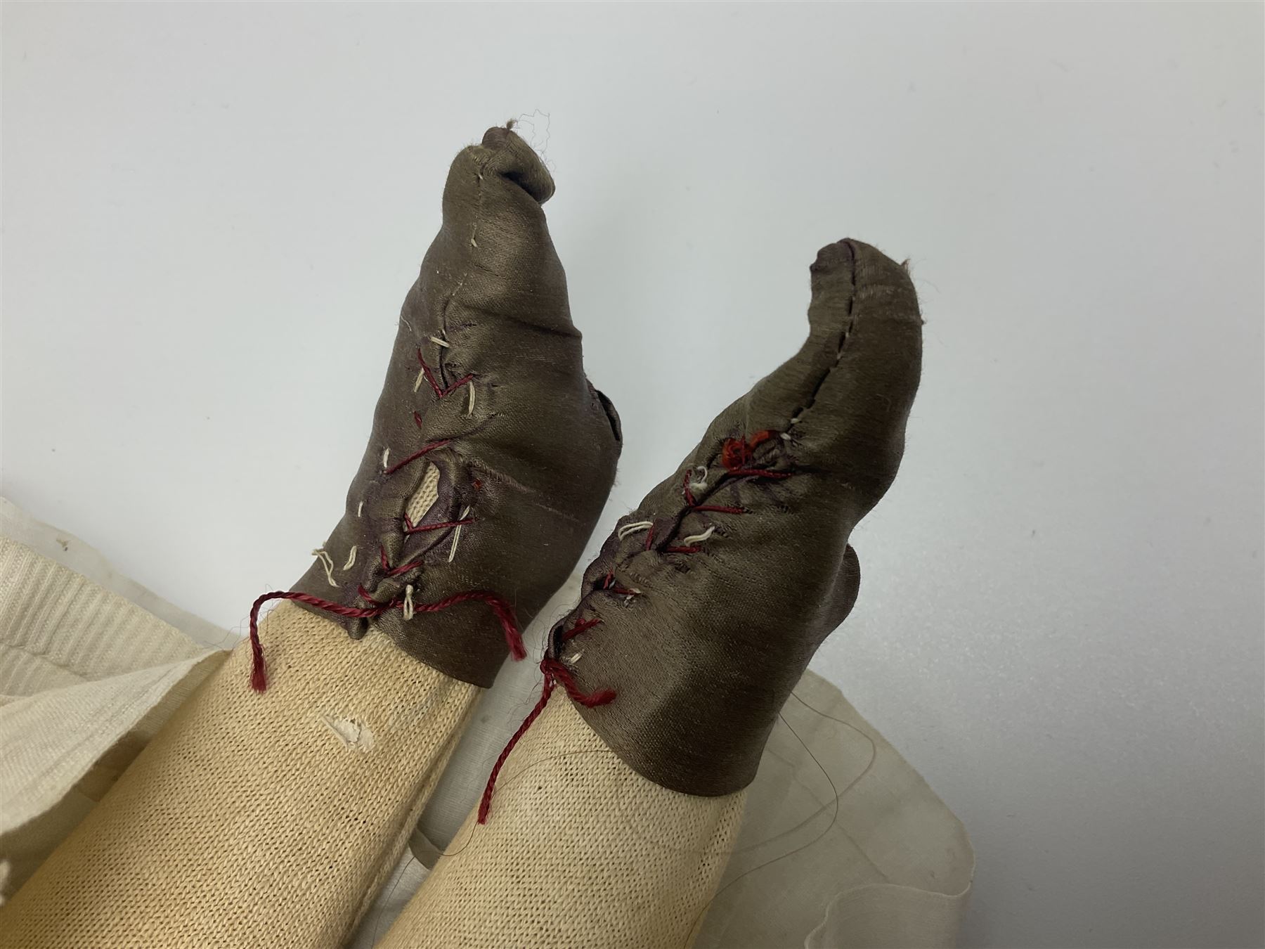 Victorian wax shoulder head doll with pale complexion, applied hair, inset glass eyes and fabric covered jointed body with kid leather lower arms; white linen dress and undergarments H50cm