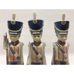 Three Lladro soldier figures, comprising Cadet Captain no 5404, Flag Bearer no 5405 and At Attention no 5407, all with original boxes, H30.5cm  