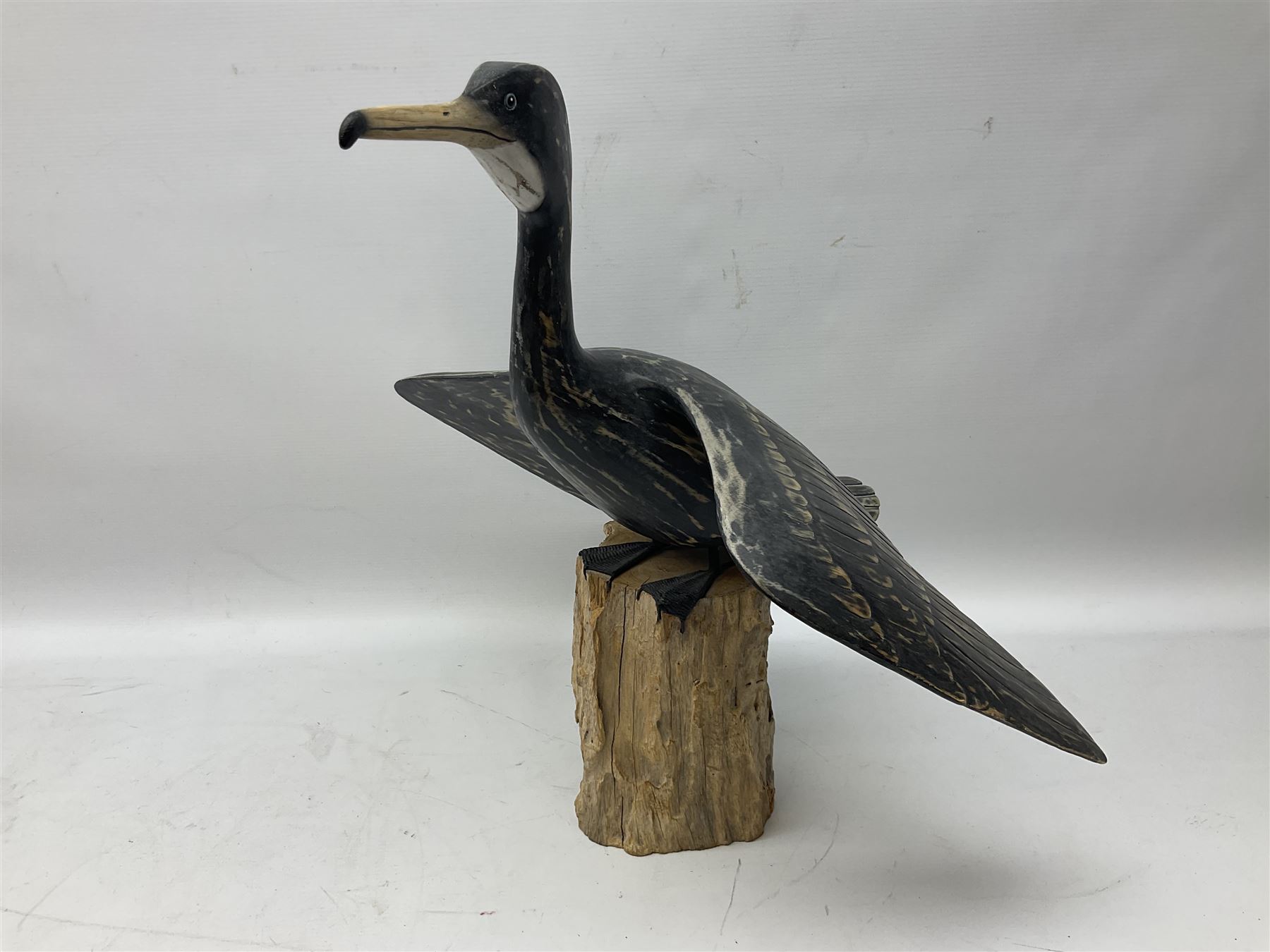 Wooden sculpture of Cormorant aquatic bird on a naturalistic wooden plinth, H46cm