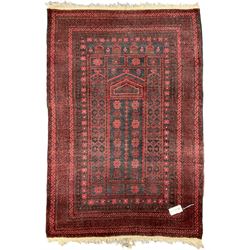Persian indigo ground pray rug, decorated with geometric bands and stylised flower heads (137cm x 90cm); and a small red ground prayer rug (117cm x 77cm)