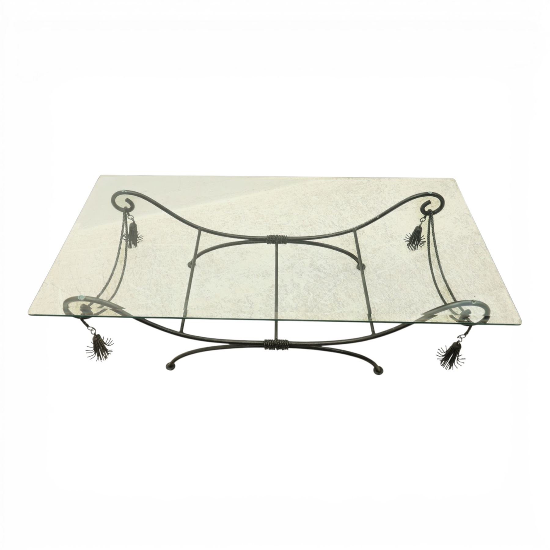 In the manner of Maison Jansen - Regency inspired glass and wrought metal coffee table with scrolling X-form base