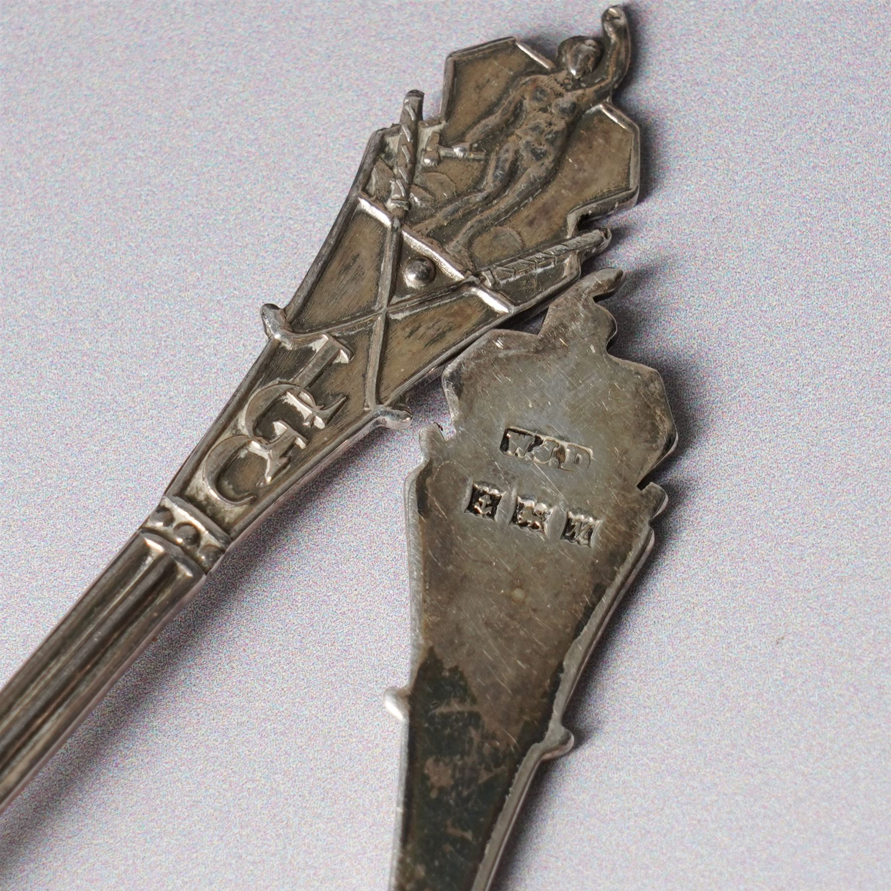 George III silver cream jug with crimped rim and scroll handle, Victorian silver cream jug with embossed decoration Birmingham 1888 and three silver golf spoons Birmingham 1961