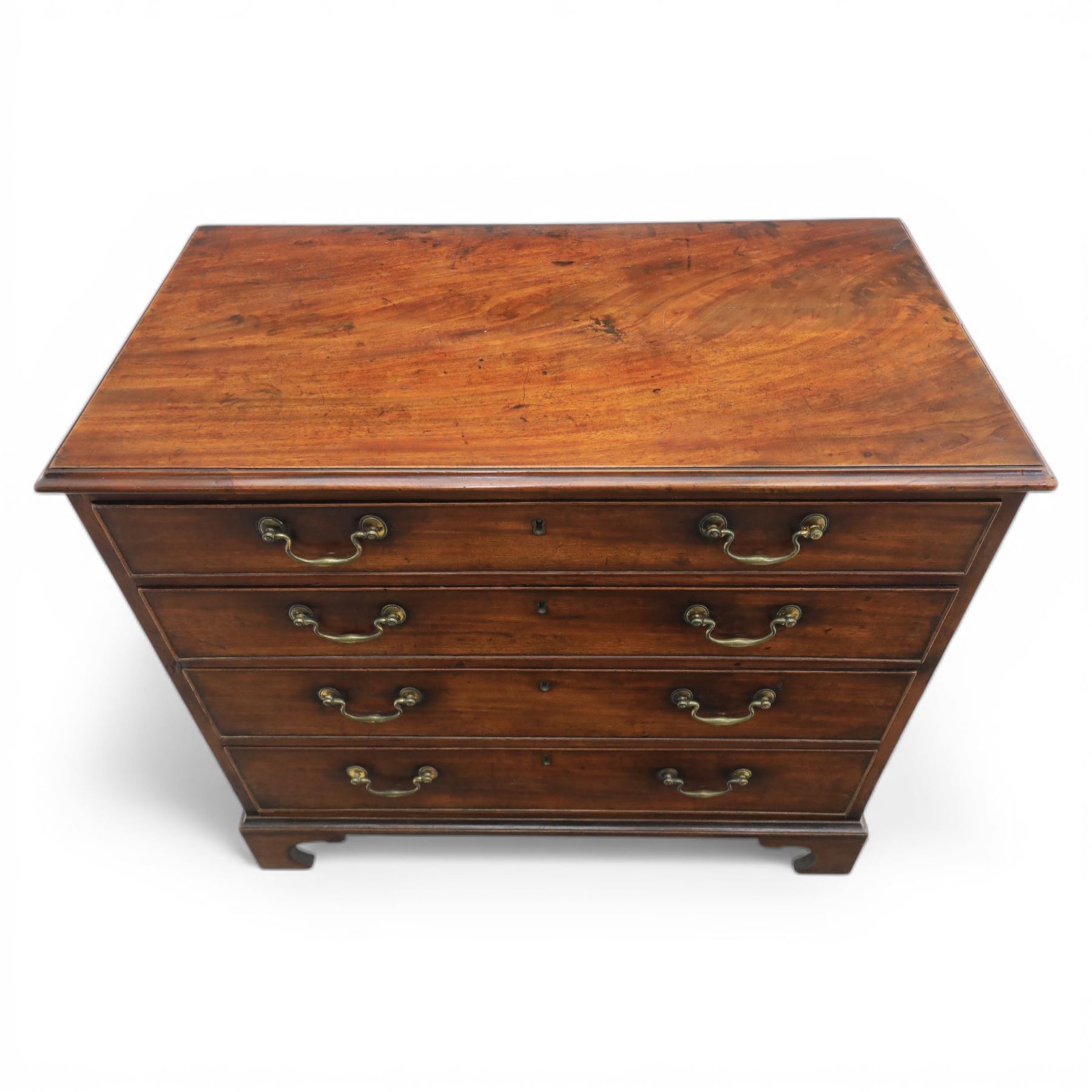 George III mahogany chest, fitted with four graduating drawers, rectangular flamed mahogany top with moulded edge, above four graduated drawers with brass swan neck handles, raised on bracket feet