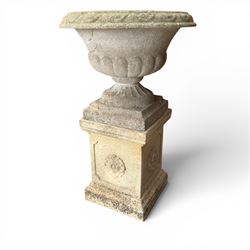 Weathered cast stone statue of a child and urn planter on pedestal along with three piece bird bath