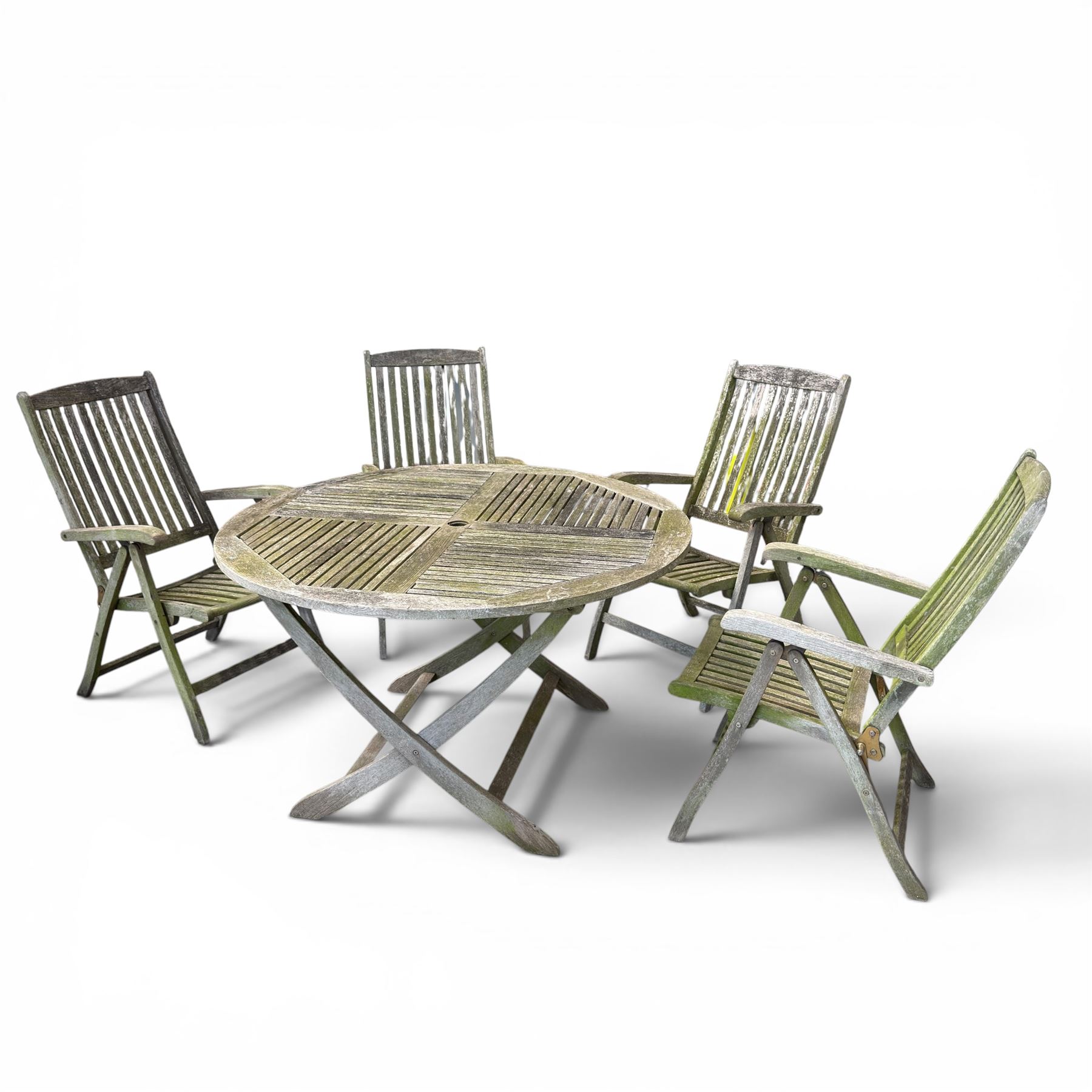 Five piece teak garden dining set, comprising circular folding table and four folding armchairs, with slatted seats and backs in a weathered finish