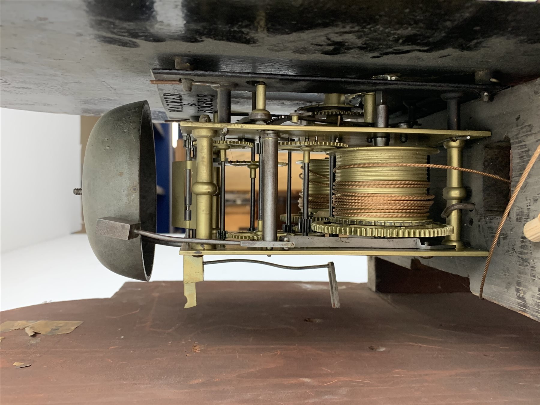 George III mahogany longcase clock, the hood with stepped moulded arch pediment above glazed door, fret work grille to each side, figured trunk door and base, enamel Arabic dial painted with country house scene and floral spandrels signed 'S. Wright, Watford', subsidiary seconds dial and date aperture, eight day movement striking the hours on bell, H212cm (two weights and pendulum)
