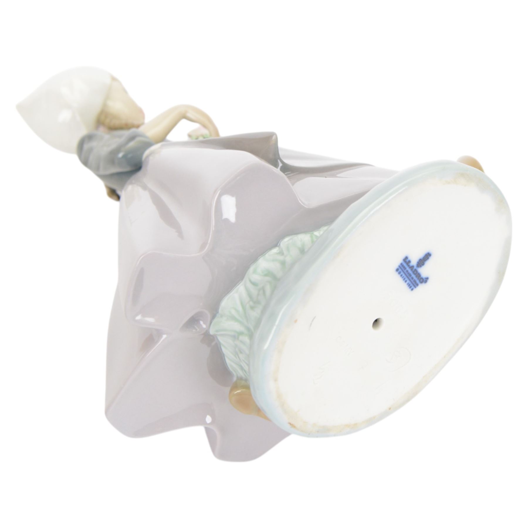 Three Lladro figures, comprising Spring Awakening 1283, Flower Harmony 1418 and Dutch girl with Tulips 5065