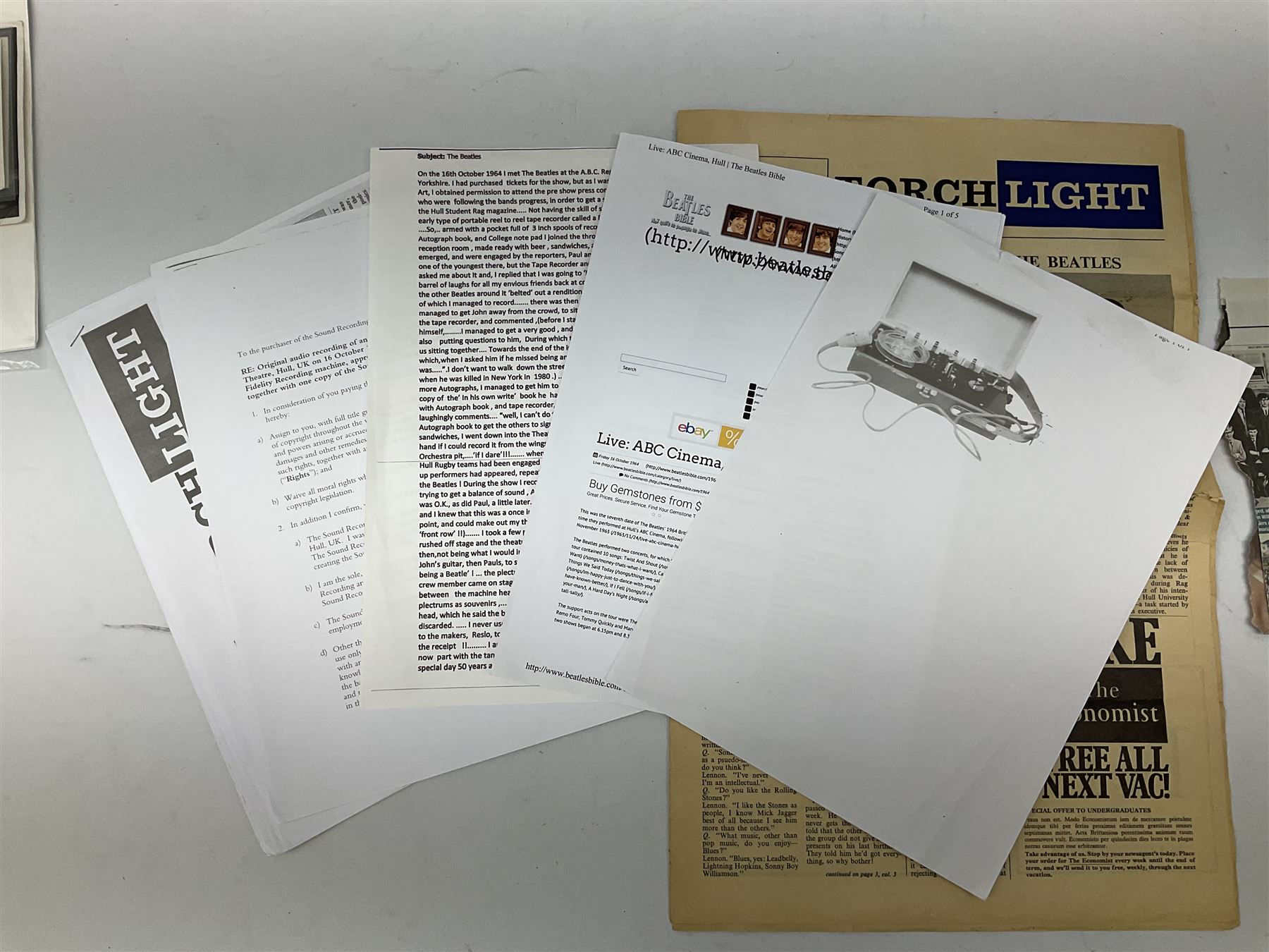 John Lennon interview recording conducted by John Hill student of Hull University on the 16th October 1964 at the A.B.C. Theatre Hull on behalf of the university newspaper 'Torchlight'. The interview lasts eight and a half minutes. It catches John in an upbeat breezy mood answering questions about the following topics: the song writing process ('sometimes you get an idea ....I dunno....my left leg.... and then write about that....'), recording (.... 'they just say - you're recording on such and such a date and they hope we turn up with some good songs written ....'), an alternative career path (.... 'I'd probably just have been a lay-about....'), failing at college (....'some other lads did my exams for me ....'), reading matter ( Clockwork Orange, Alice in Wonderland), his books of prose, tastes in music, the Blues, The Rolling Stones, being a Beatle vis-a-vis anonymity ('Whatever I'd be I'd choose to be rich .... who wants to walk down the street?').
The interview was recorded on 1/4 inch Emitape on a Fi-Cord Fidelity Recording machine. The reel-to-reel tape comes in its original Emitape plastic box and is accompanied by the Fi-Cord reel-to-reel machine on which the interview was originally recorded. Also included in this lot are a copy of the 'Torchlight' newspaper from 21st November 1964, two photographs of the interviewer with John Lennon (the interviewer is pictured to the left of John Lennon in the photograph in which John is signing a sketch) and one photograph of Paul McCartney with another reporter, the largest measures 12 x 16.5cm and a transcript of the interview. The recording is also accompanied by the original Fi-Cord tape recorder with microphone, four original 2v batteries and battery charger. The tape recorder has been adapted to take 3xAA batteries and the 2v battery charger is fitted with a standard UK 3-pin AC plug. The interview was recorded in the press room prior to the Beatles concert at the A.B.C. Theatre and is sold with copyright.