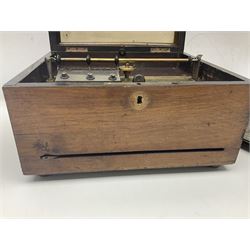 Late 19th century Symphonion disc musical box for spares or repair, inlaid walnut case with front lever action, playing 25.5cm discs on a 10.5cm steel comb with forty-nine teeth, musical scene of cherubs under the lid, L33cm; together with twelve 25.5cm discs