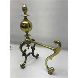Pair of early 20th century brass fire dogs, each with sphere and urn finial, upon a scrolling base, H38cm