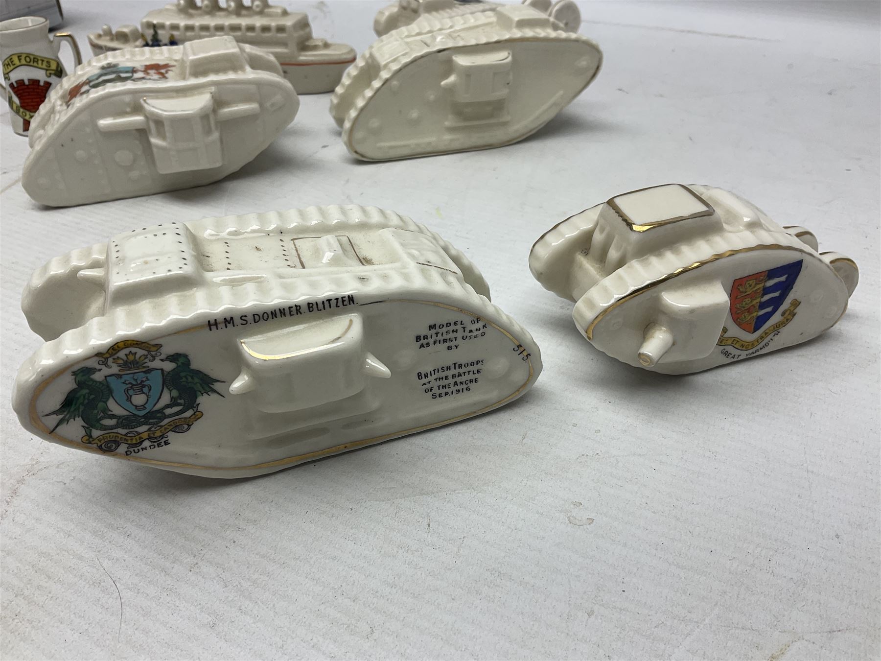 Twelve crested china models of WW1 tanks by Grafton, Arcadian and Carlton china etc with crests from Caistor Lincs, Saffron Walden, Paignton, Evesham etc  , together with a crested china model of the R.M.S Lusitania with New Brighton crest and a two-handled vase for 'The Forts Boxhill' (14)