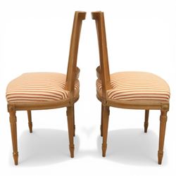 20th century Louis XVI style beech salon suite, comprising settee and four chairs, the settee with shaped rectangular back and upholstered arms over a shaped seat, the chairs with rectangular backs and overstuffed seats, each upholstered in striped fabric with close-nailed borders, upon fluted tapering supports headed by carved paterae, terminating in toupie feet, chairs H89cm W47cm