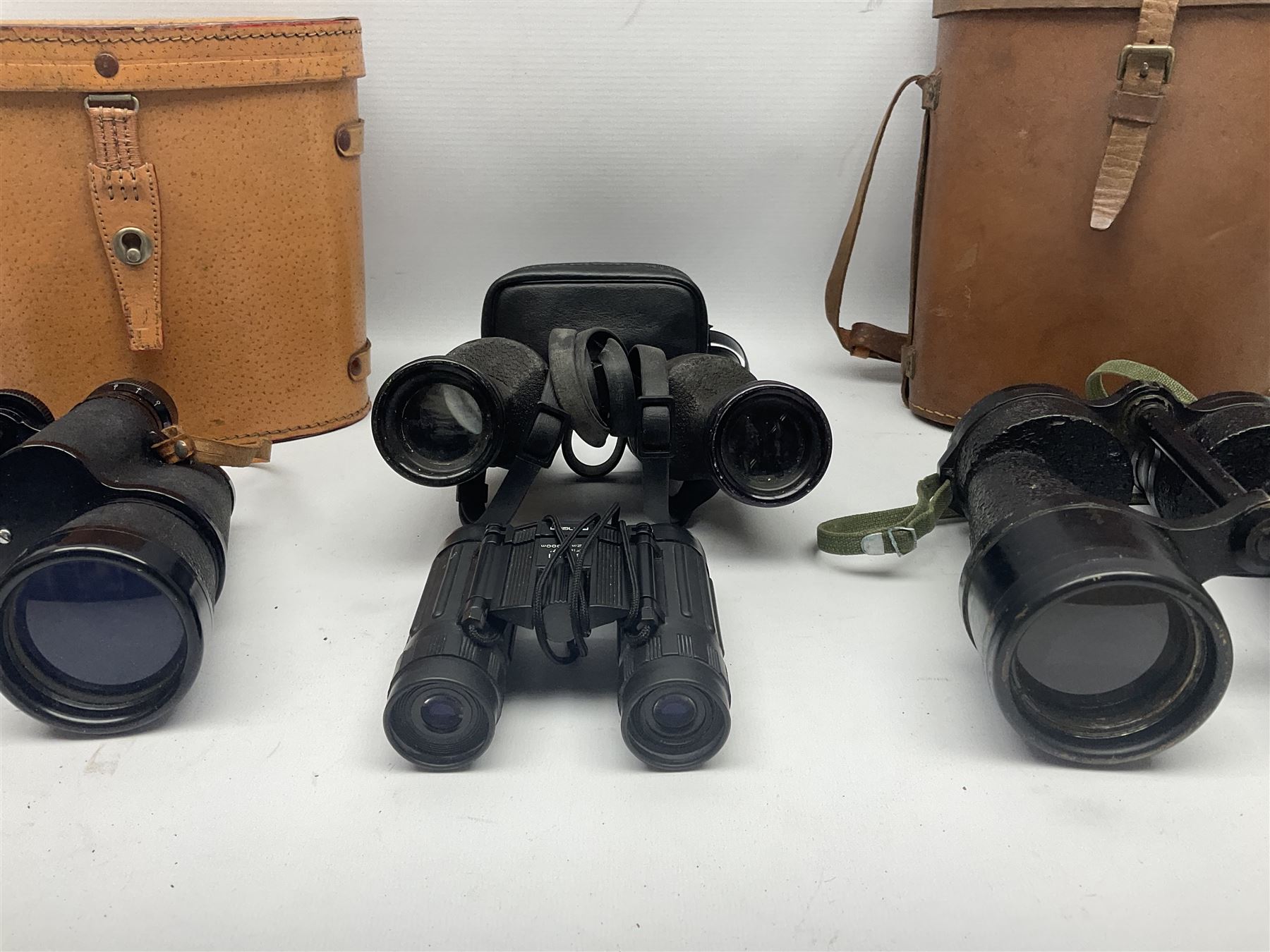 Pair of British World War Two issue black-painted binoculars, Bino 7x50 No. 5, 6E/320, No. 87412, MoD.B/42, with case, together with Nipole 10 x 50 binoculars and two other pairs