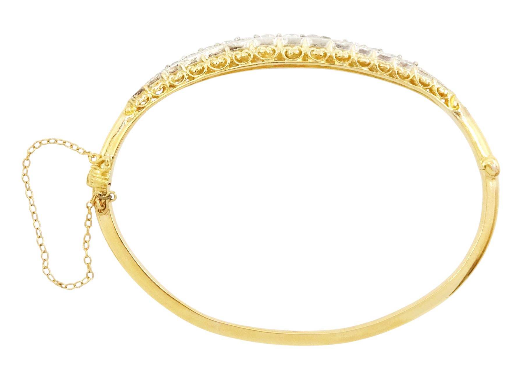 Early 20th century gold and silver diamond hinged bangle, thirteen graduating old cut diamonds, within a fancy scroll design gallery, total diamond weight approx 2.10 carat