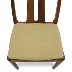 Nathan - teak drop leaf dining table and four Nathan dining chairs, the rectangular top with rounded corners fitted with twin hinged drop leaves and gate legs, extended to form an oval table 174cm in length, raised on square section supports united by stretchers, the chairs with teak frames and padded beige upholstered seat (H 96cm, W 48cm)