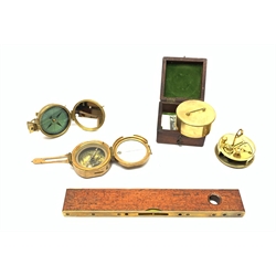 Brass Natural Sine type compass with spirit levels to the dial, bears name of Stanley, D8cm, in earlier mahogany box; brass pocket sextant of drum shaped form, the screw top marked Stanley London; small brass cased compass with pedestal tripod base; and Glass Developments Ltd. hahogany and brass spirit level L31cm (4)