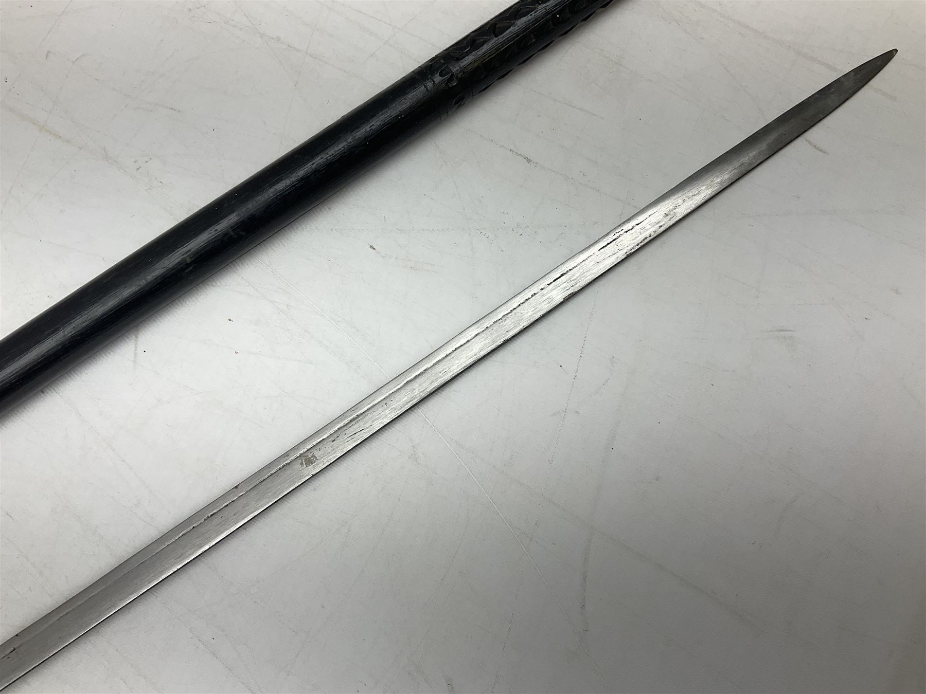 Late 19th/early 20th century Anglo Indian ebony and bone sword stick with 62cm steel blade, brass locking ferrule and lion mask pommel L92 cm.