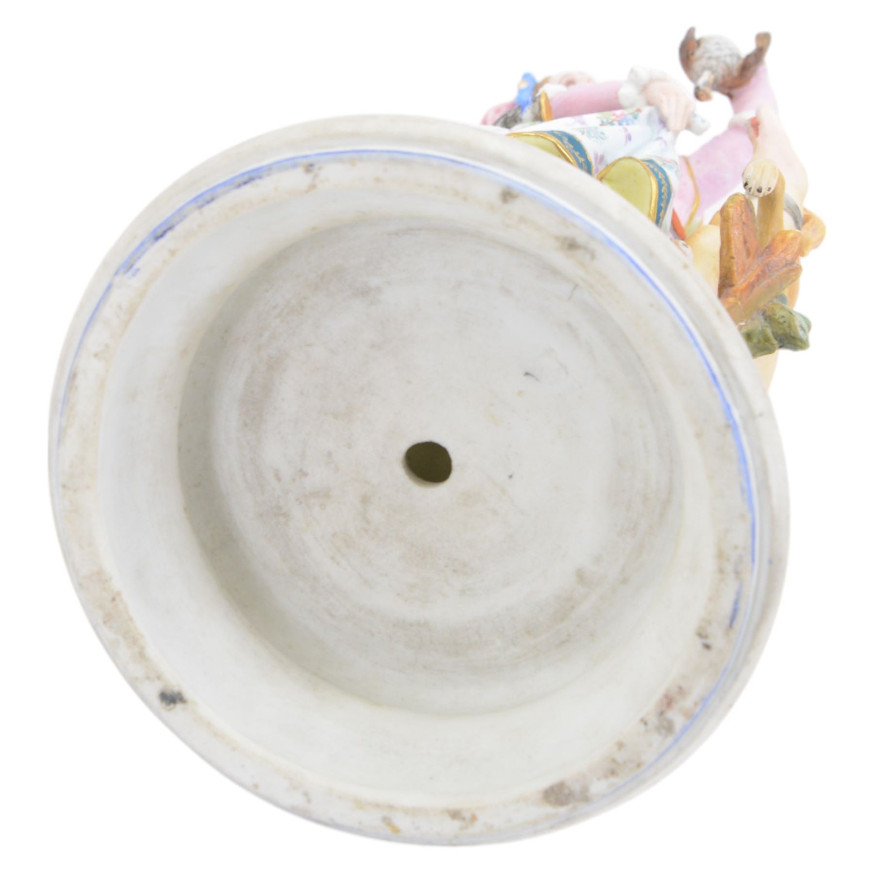 Late 19th/early 20th century Continental bisque figures, the larger modelled as a pensive female figure sitting upon a well, upon an oval naturalistically modelled base, H39cm, the smaller modelled as a hunts woman holding a bird aloft, with hound by her side, upon a socle base, H35cm