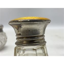 Three glass dressing table jars with silver covers, to include an example with yellow guilloche enamel and silver cover, hallmarked Birmingham 1923, plus an Edwardian silver napkin ring, approximate weighable silver 44.1 grams