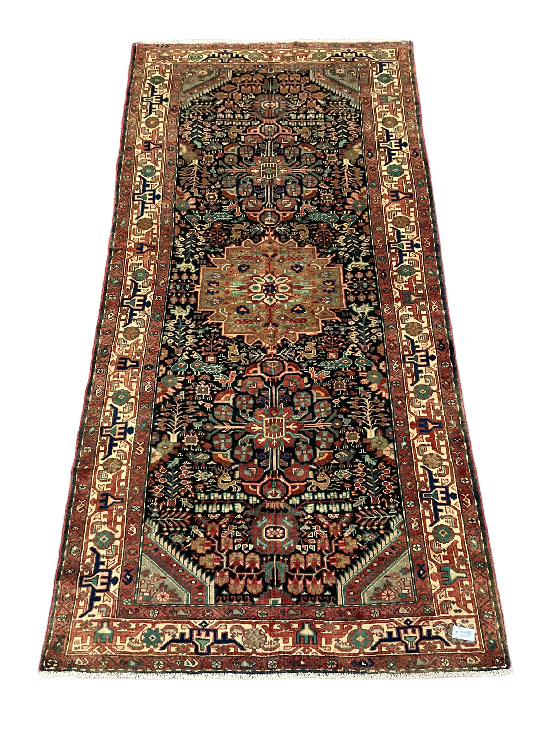 Persian Malayer rug, the field decorated with tree of life, floral, animal and bird motifs, surrounded by three band border with geometric design