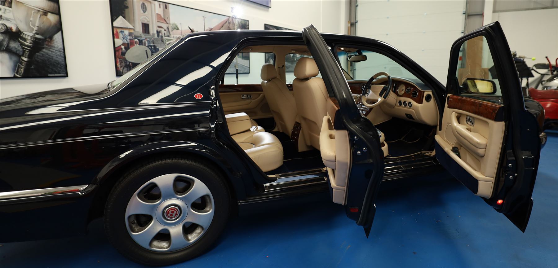 2001 Bentley Arnage Red Label Saloon

Registration: BU51 TGX
Engine: 6.75-litre turbocharged V8 petrol
Transmission: Automatic
Odometer reading: 39,942 miles
Colour: Black Sapphire metallic
Interior: Magnolia leather with burr walnut veneers
Previous owners: 3
V5C: Present
Service history: Good service records

An exceptional Bentley Arnage Red Label Saloon, finished in Black Sapphire metallic, a very dark blue, with a Magnolia leather interior, contrasting dark blue carpets and extensive burr walnut veneers. The car displays an odometer reading of approximately 39,942 miles.

The Arnage Red Label combined Bentley’s renowned 6.75-litre turbocharged V8 engine with automatic transmission, delivering effortless performance in a traditionally appointed luxury saloon. The model is distinguished by its imposing proportions, characteristic Bentley radiator grille and finely crafted interior.

Presented in excellent condition throughout, the bodywork and metallic paint finish appear particularly well preserved, complemented by clean brightwork and the correct Bentley alloy wheels. The engine bay is also notably well detailed.

The interior presents exceptionally well, retaining its Magnolia leather upholstery, polished burr walnut veneers, original factory instrumentation and switchgear. The leather displays only light creasing consistent with careful use.

The car has had three previous owners and is accompanied by good service records.

Features

• 6.75-litre turbocharged V8 petrol engine
• Automatic transmission
• Black Sapphire metallic paintwork
• Magnolia leather interior
• Contrasting dark blue carpets
• Burr walnut veneers
• Electrically adjustable front seats
• Air conditioning
• Factory instrumentation and switchgear
• Bentley alloy wheels
• Right-hand drive
• Odometer reading of approximately 39,942 miles
• Three previous owners
• Good service records
• V5C present

This vehicle forms part of the Estate of the Late John Sills and is offered for sale by the Executors, confirming a genuine reason for sale.