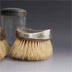 1920s gentleman's travelling case by Mappin & Webb Ltd, tan leather impressed with initials NAO, opening to reveal a compartmentalised interior containing silver mounted dressing table items, including a pair of silver mounted brushes, engraved NAO AMA 1918, hallmarked William Comyns, London 1911, five faceted glass jars and bottles with silver lids and a silver shaving brush holder, all hallmarked Mappin & Webb Ltd, London 1922, tan leather box containing razor, silver plated shoe horn, scissors and bevelled edge shaving mirror with easel support