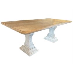 Classical Grecian design Carrera marble centre table, the rectangular single slab top with rounded corners and carved edge, raised on twin pedestals comprised of three pieces with a waisted column on a stepped plinth