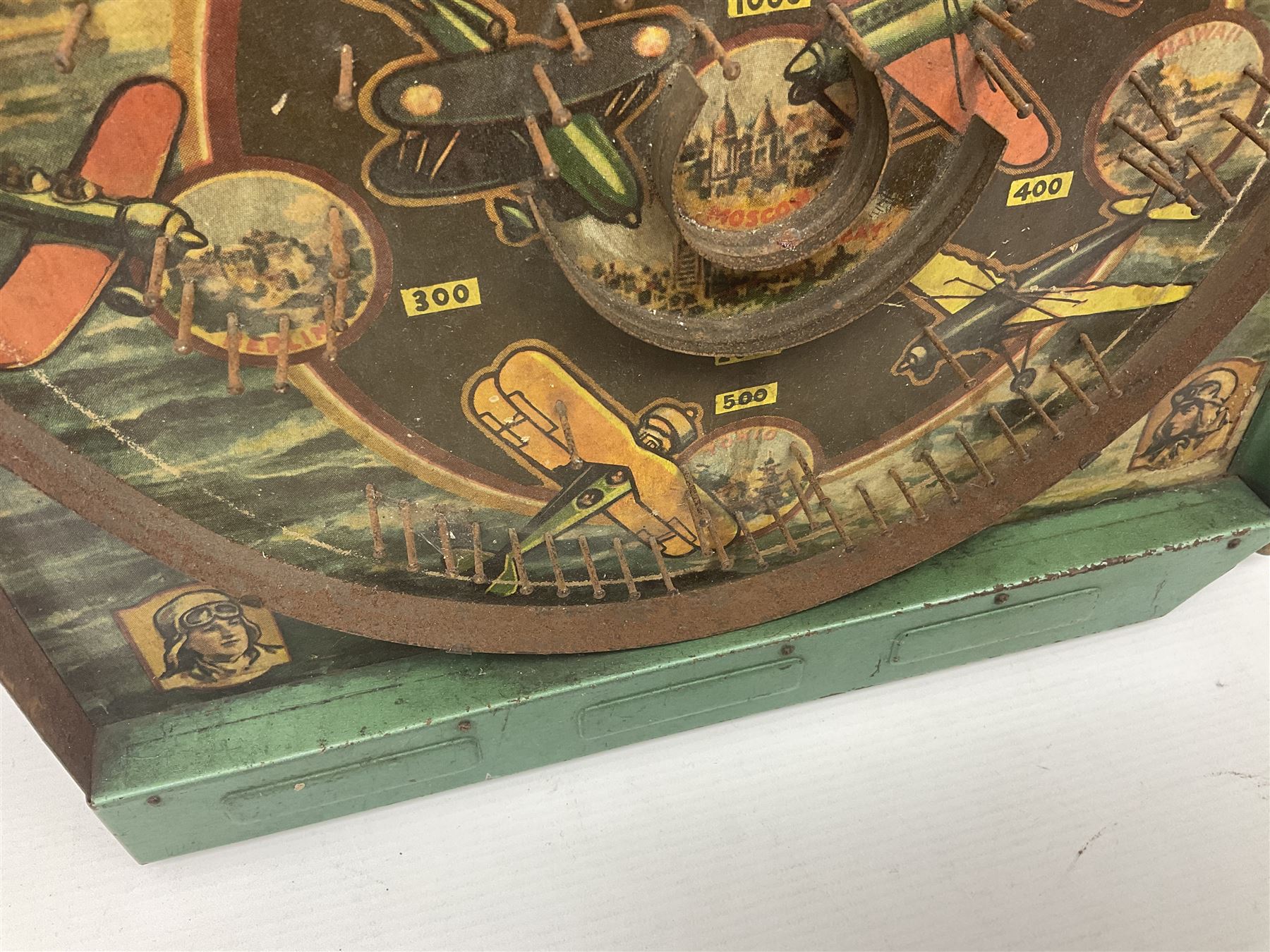 1934 Lindstrom's 'Airways' tin-plate bagatelle game by Lindstrom Tool and Toy Company Bridgeport Conn., the decorative bagatelle board depicting Lindstrom's epic airway routes; with wooden peg and quantity of balls H61cm