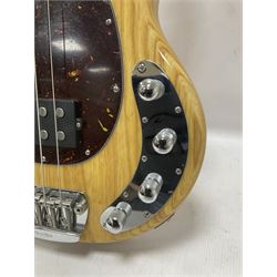 Ernie Ball Music Man Sting Ray 4 string bass guitar, in natural finish with roasted maple neck and tortoiseshell effect scratch guard, serial no 87485, in black Music Man hard case, guitar L114cm