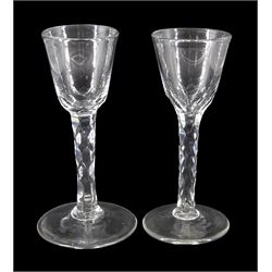 Two late 18th century drinking glasses, the funnel bowls upon diamond faceted stems and circular feet, each approximately H14.5cm