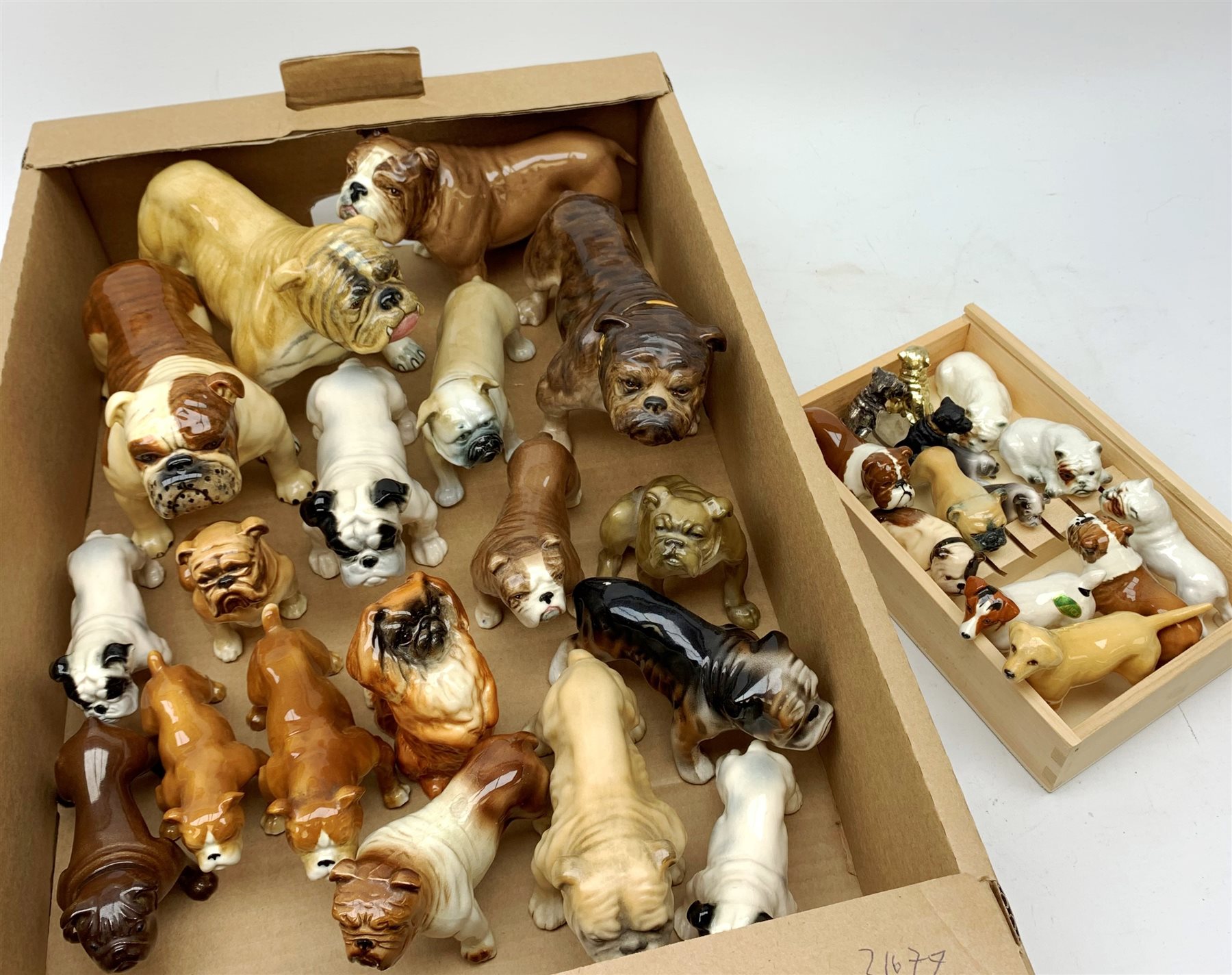 A large collection of mainly Bulldog and other dog figurines, to include a number of examples by Beswick, Sylvac, and one by Royal Doulton, 