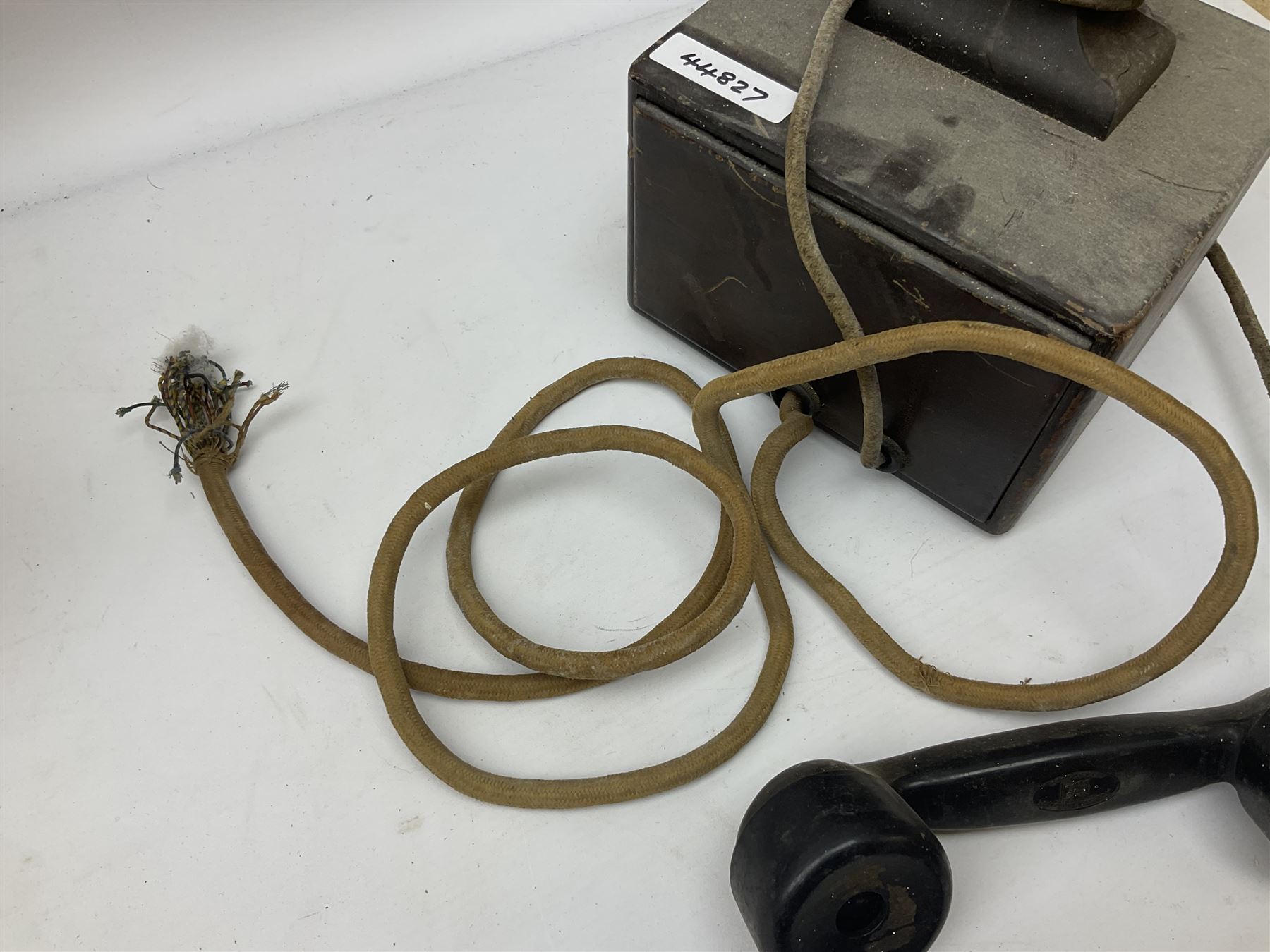 Early-mid 20th century internal telephone system, comprising exchange box with attached TMC rotary telephone and dictograph with Bakelite handset and support upon stained wood case, and 1960s black Bakelite telephone model 312L with G.P.O sticker beneath, largest H30.5cm W36.5cm D30cm