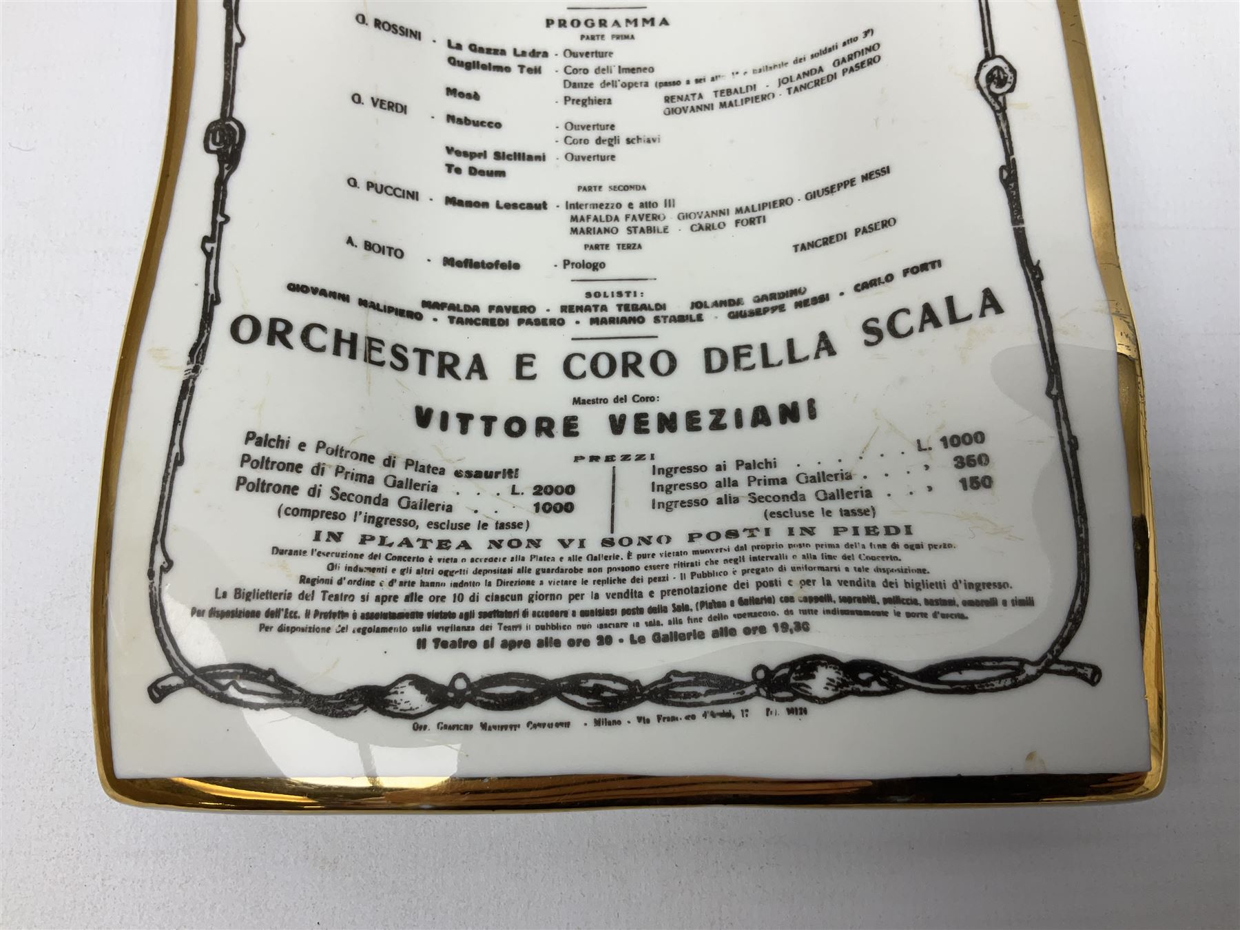 Fornasetti rectangular 'Toscanni's Concert' poster ashtray decorated with black and white text with a gilt border edge, with printed mark beneath, H22cm 