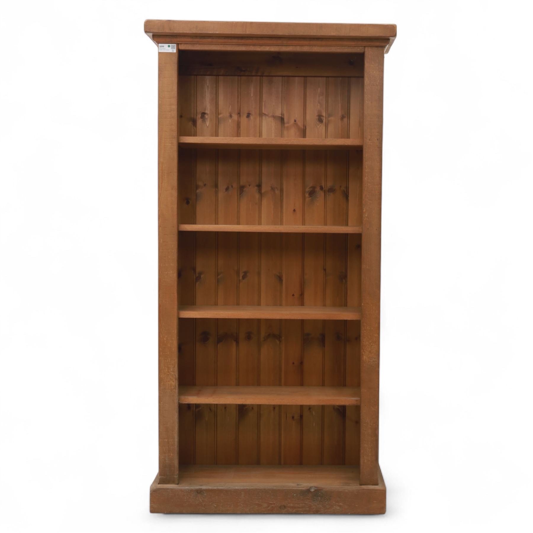 Contemporary oak open bookcase, with moulded cornice above five fixed shelves and boarded back, on plinth base