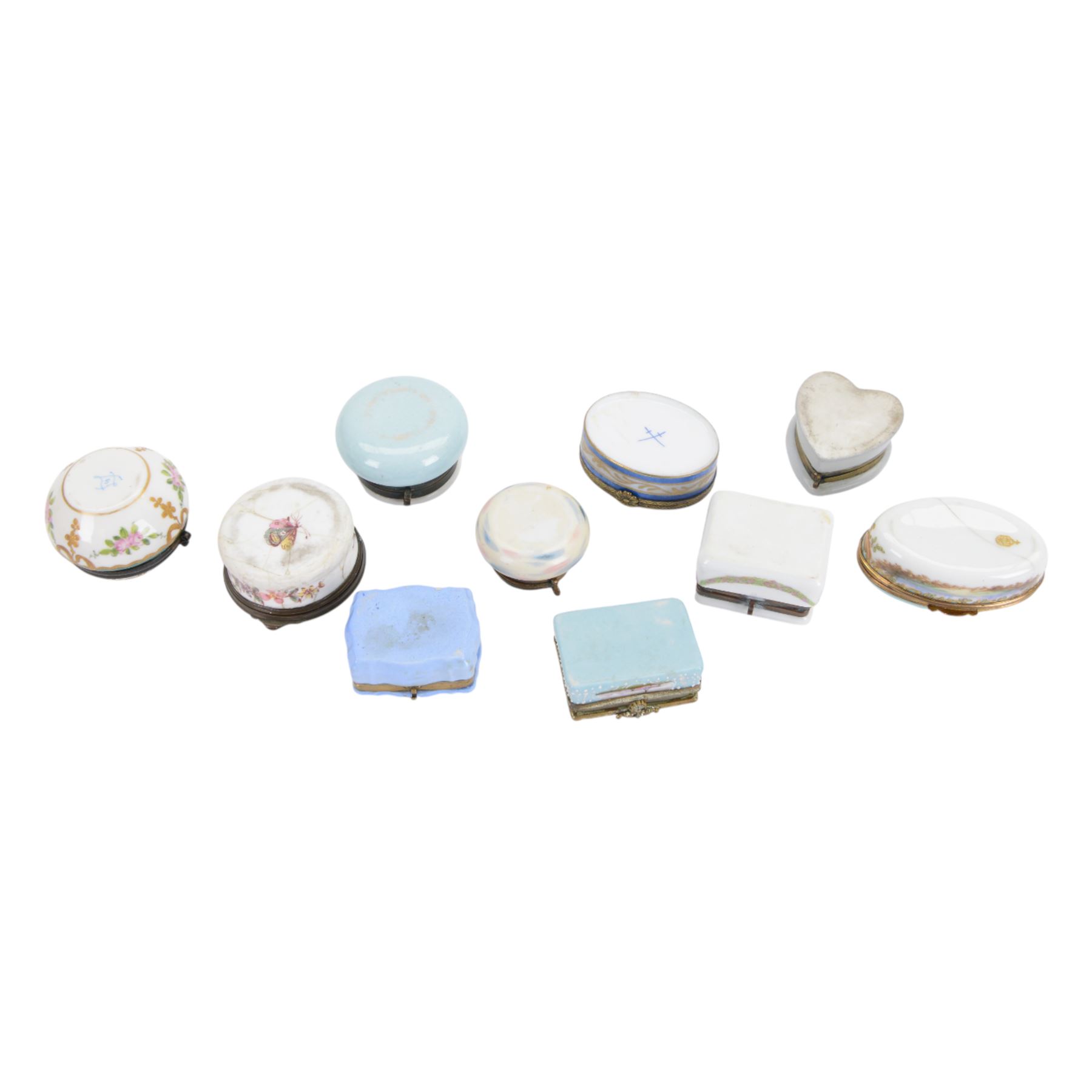 Ten porcelain boxes, of various form, each with printed decoration of figures