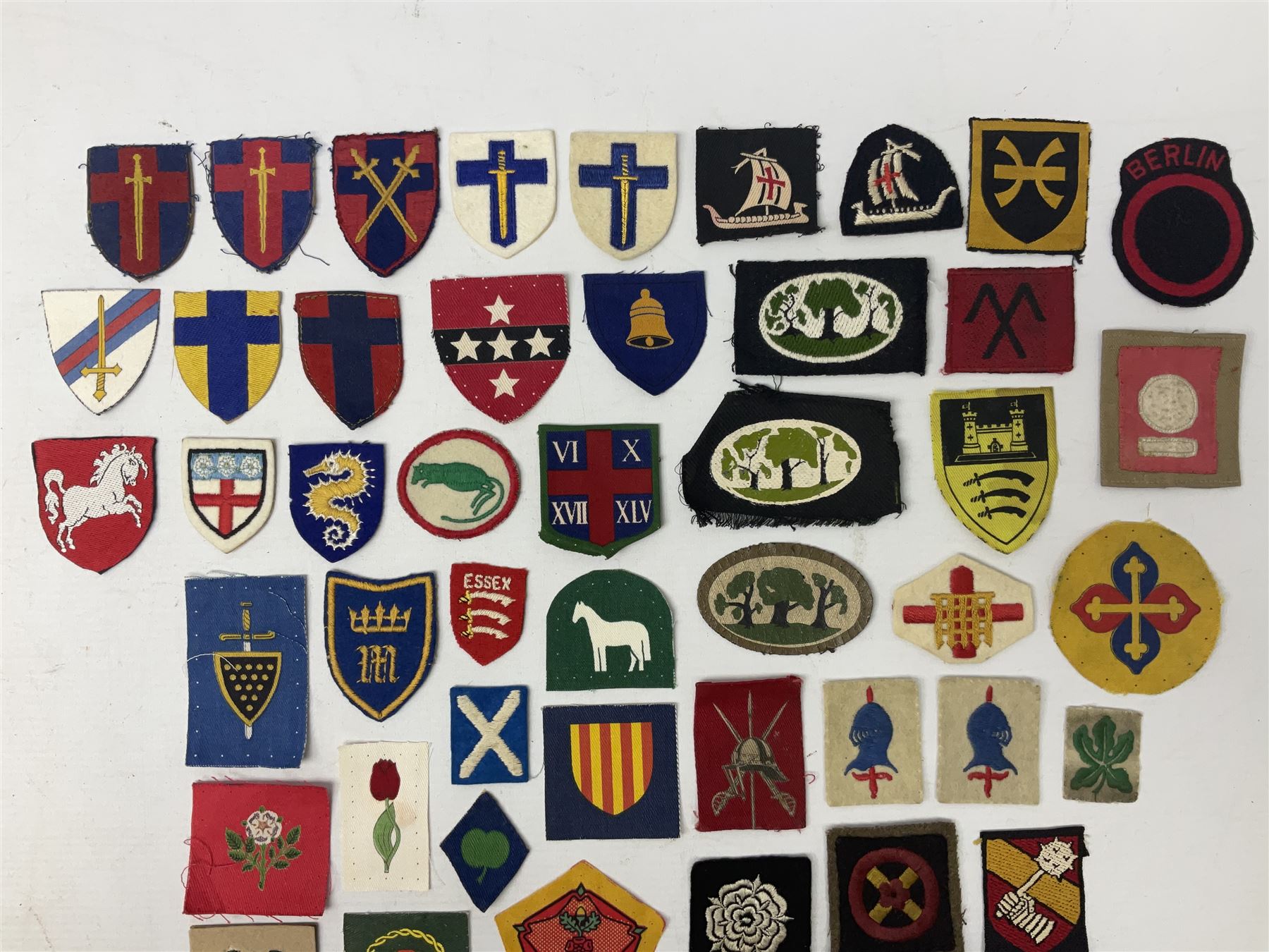 Approximately one-hundred printed and embroidered cloth badges including I, II, VIII, XI, XII and XXX Corps, Eastern Command, various Armoured Divisions, Midland, Wessex, Home Counties and 12th Infantry Brigades, Salisbury Plain, Northumberland, Hampshire, North Midland, West Riding, Essex and Suffolk Districts, Berlin & Rhine Army Troops etc