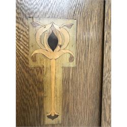 Arts and Crafts period oak wardrobe, projecting shaped cornice, single bevel edged mirrored door above drawer